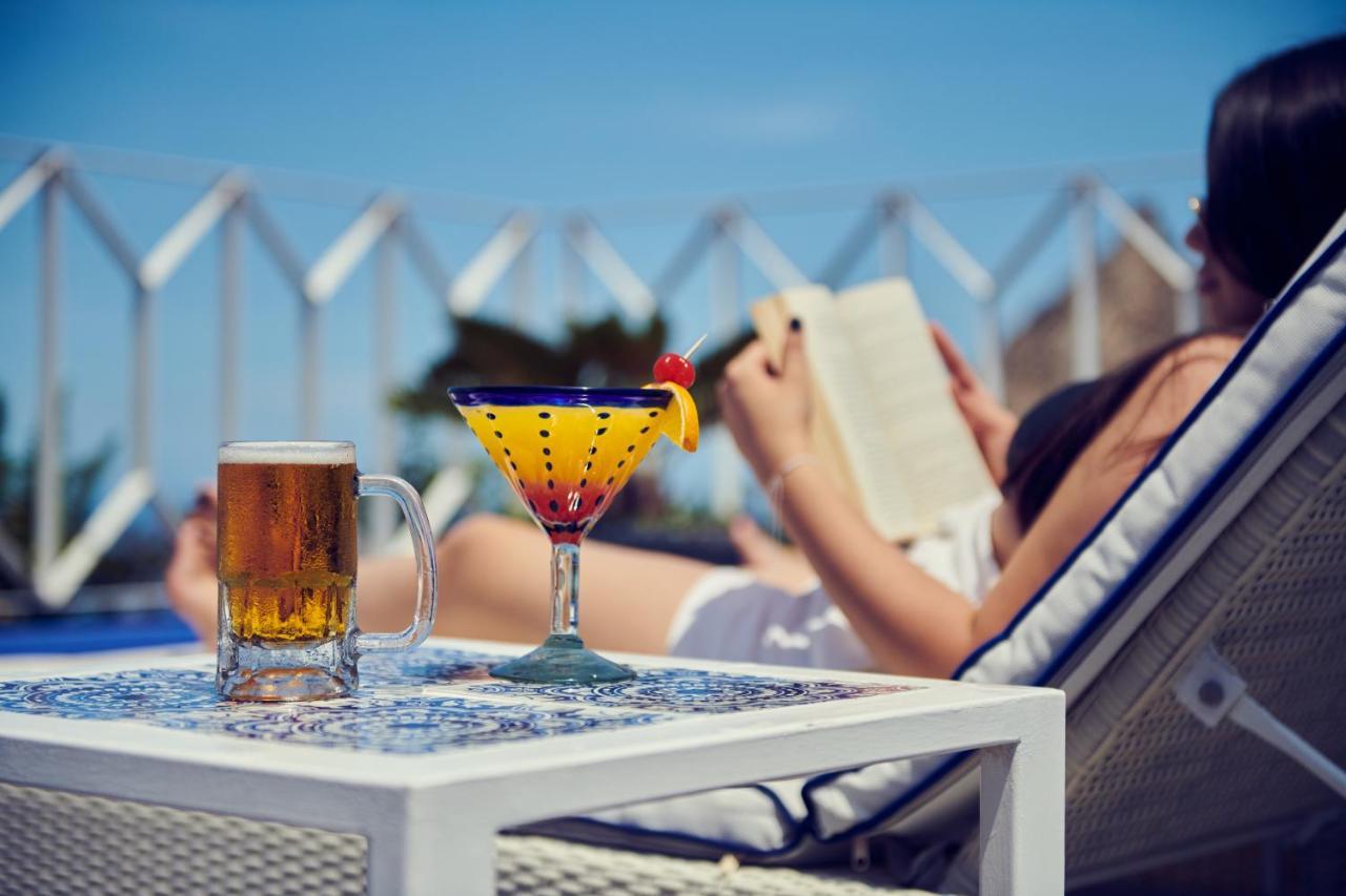 Hotel Luxury Patio Azul (Adults Only) Puerto Vallarta Esterno foto A woman reading a book by the pool